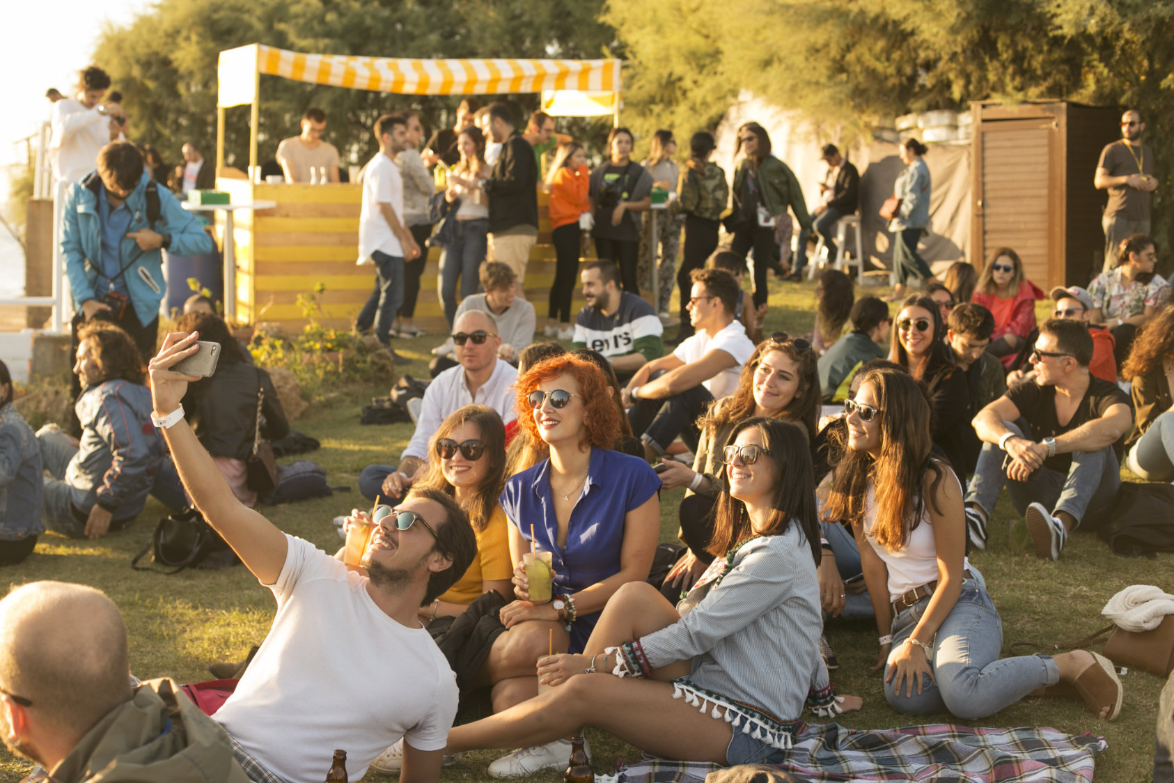 A wide SUNDAZE gathering across the waterfront lawn