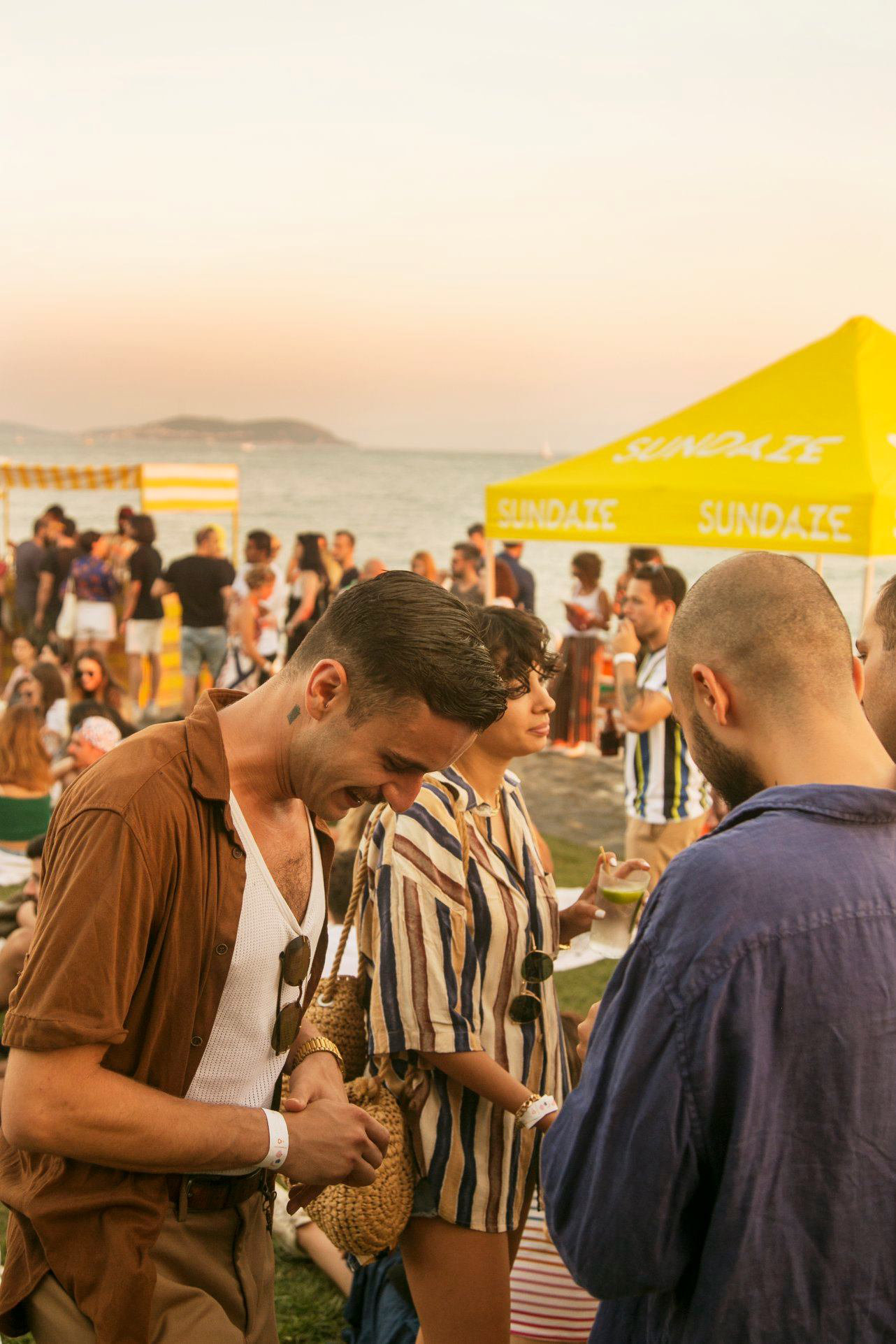 SUNDAZE guests arriving beside the yellow waterfront pavilion